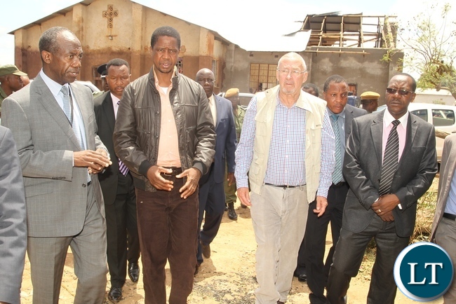 DMMU Coordinator Patrick Kangwa shows round the affected area in Baulini to President Edgar Lungu and PF Lusaka Central Member of Parliament Guy Scot during the tour of the effected houses in Baulini