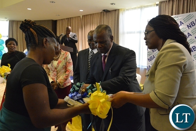 Higher Education Minister Micheal Kaingu officially launches the booklet of the National Biosafety Authority while the Director of science and technology in the ministry of higher education Jane Chinkusu helps him this was during the launch of National Biosafety Authority