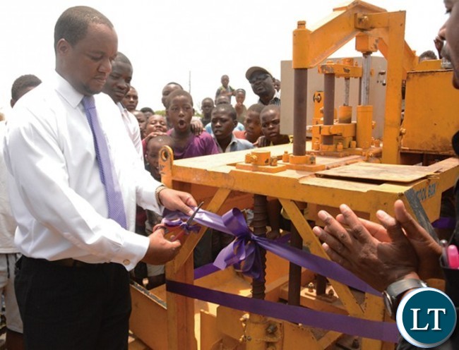 Matero MP Mr Miles Sampa cutoff the ribbon during the handing over of industrial block making machine to the Youths in matero Matero MP Mr Miles Sampa cutoff the ribbon during the handing over of industrial block making machine to the Youths in matero