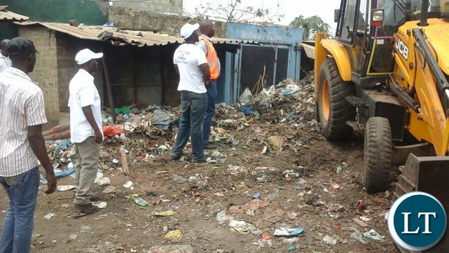 Bowman Lusambo and his 2016 Campaign Team inspects works at the market