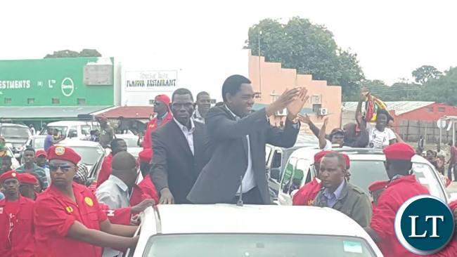 HH gestures to his supporters upon arrival in Mongu
