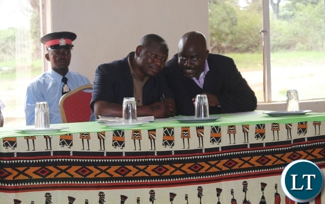 Mbala District Commssioner, Kedrick Sikombe (l) sharing notes with District Administrative Officer, Felix Mungaila during the celebrations of 16 Days of Activism