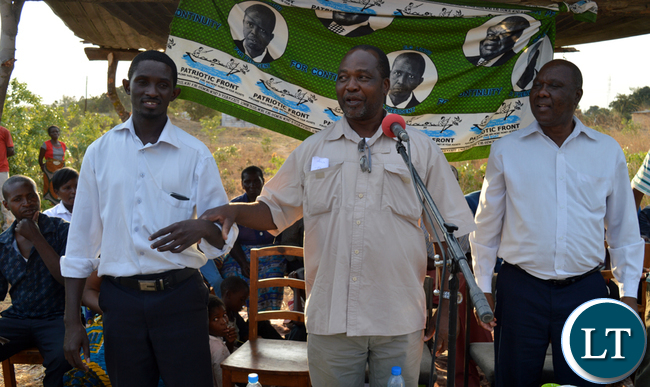 Patriotic Front Member of the Central Committee Syacheye Madyenkuku (middle) introduces Choma central Constituency party secretary Joel Kamoko to the residents (not in picture) of Sikalongo ward while constituency chairperson Timothy Siakaziba looks on