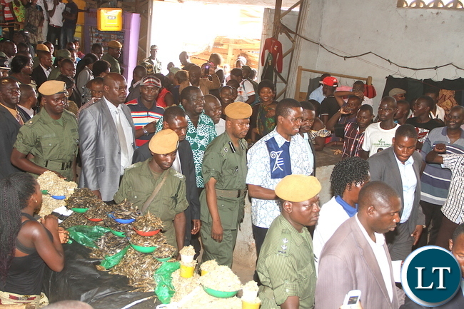 President Lungu lifts a Baby during a tour of Kalulushi Market on the Copperbelt on Monday, November 2,2015 -Pictures by THOMAS NSAMA