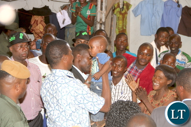 President Lungu lifts a Baby during a tour of Kalulushi Market on the Copperbelt on Monday, November 2,2015 -Pictures by THOMAS NSAMA