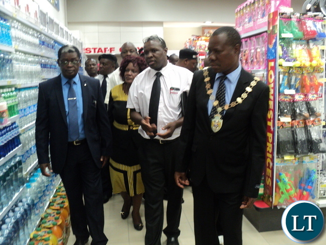 From left to right Chingola Mayor Titus Tembo, Shoprite Director charles Bota and Copperbelt Province Permanent Secretary Haward Sikwela touring Shorite after official launch