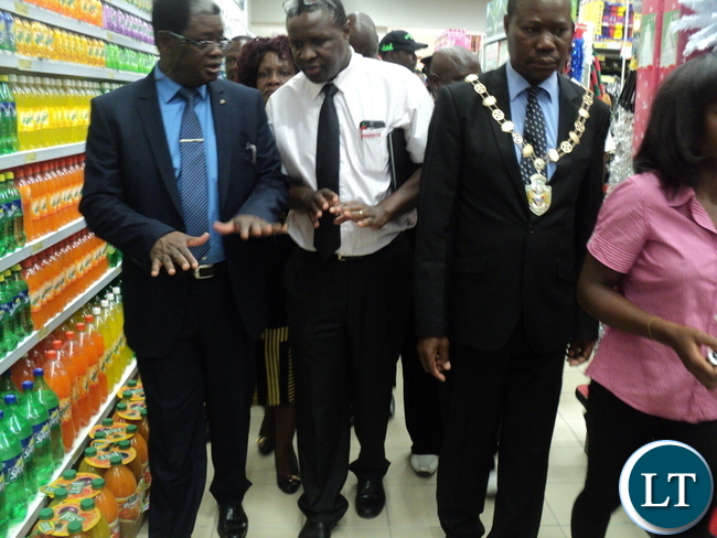 Copperbelt Province Permanent Secretary Haward Sikwela being shown the products by Shoprite Director Charles Bota at Chingola Shoping Mall.