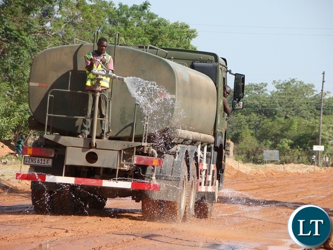 ZAMBIA National Service has been empowered with some more road equipment machinery by the government. In the picture is a water bowser truck watering in of the Mochipapa township roads in Choma.