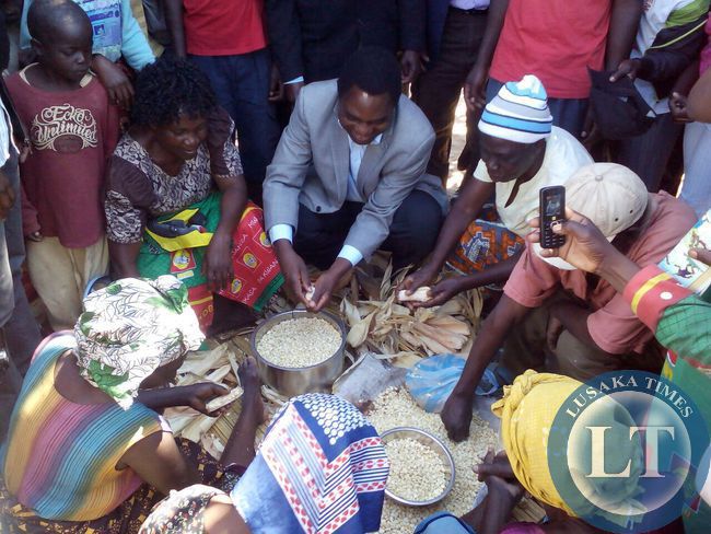 UPND president Hakainde Hichilema helping the women in Matero
