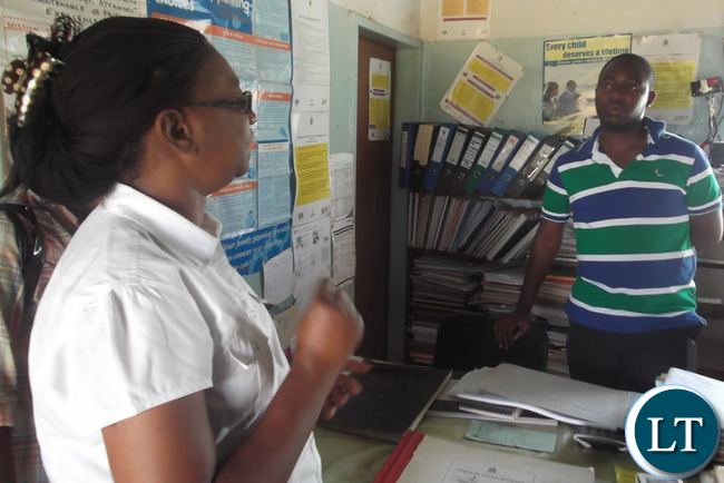 United Nations Population Fund Luapula Province Programme Manager Florence Mulenga engages Nsonga Rural Health Center Nurse – in – Charge Clive Lombe on the need to restock Partographs at the center as an effective aid in monitoring the performance of women in labour during delivery