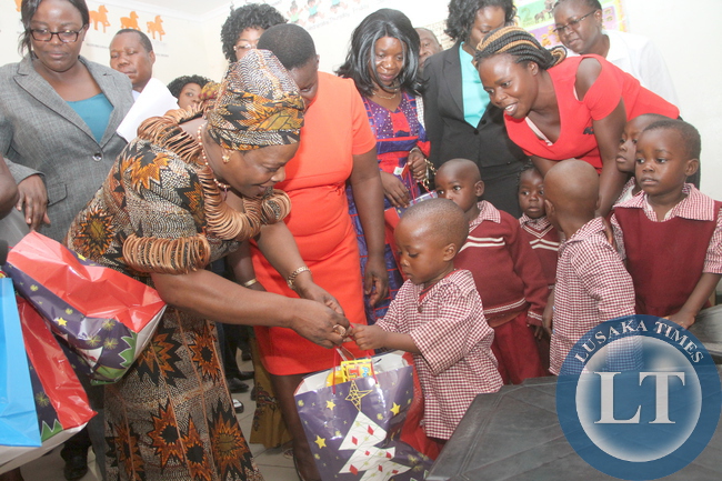 First Lady Esther Lungu presents Christmas gifts to nursery School children at Ndeleni Children Centre that was initiated by KCM at Chiwempala Market in Chingola on Monday, December 7,2015. The First Lady is in Chingola to check and witness various projects that are being undertaken by various stakeholders and those that are undertaken by Konkola Copper Mine (KCM) under Corporate Social responsibility -Picture by THOMAS NSAMA