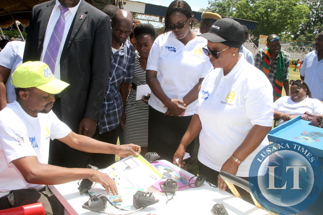 First Lady Esther Lungu being attended to by David Miti during the Commemoration of the International Day for Persons with Disabilities on Thursday, December 3,2015 -Picture by THOMAS NSAMA