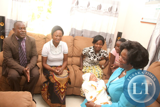 First Lady Esther Lungu took time off her busy schedules and visited families of State House staff. Here, First Lady Esther Pose for a photograph with children when she visited State House police Camp. Here, First Lady Esther Lungu when she visited Chief Inspector James Phiri's family. The First Lady wanted to see how members of staff and their families are living in a Police Camp on Thursday, December 10,2015 -Picture by THOMAS NSAMA