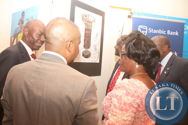 First Lady Esther Lungu admires the paintings during the 69th Anniversary celebrations of UNICEF at Pamodzi Hotel in Lusaka on Thursday evening, December 10,2015 -Picture by THOMAS NSAMA