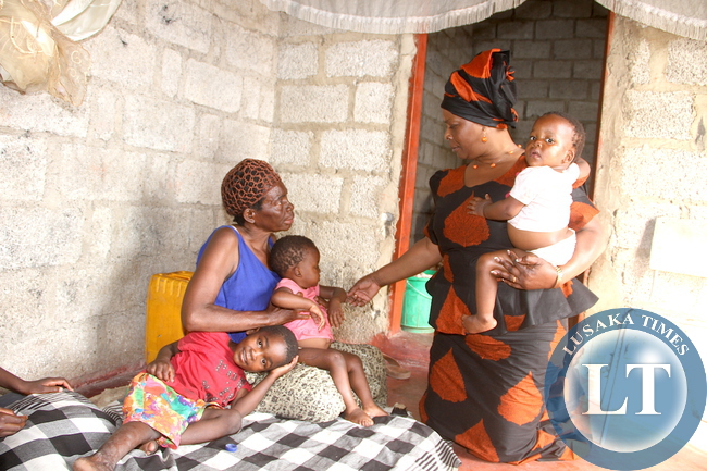 First Lady Esther Lungu when she visited 56 year-old widow Fan Mulimba, looking after children left by her daughter who went missing for six years. This was in Lusaka's Garden House on Sunday, December 6,2015 -Picture by THOMAS NSAMA