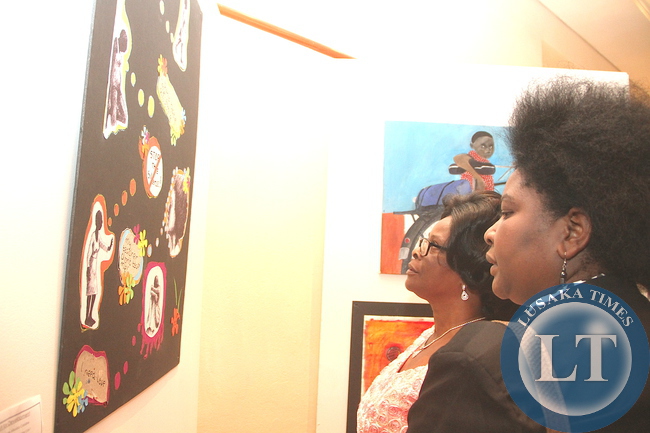 First Lady Esther Lungu admires the paintings during the 69th Anniversary celebrations of UNICEF at Pamodzi Hotel in Lusaka on Thursday evening, December 10,2015 -Picture by THOMAS NSAMA