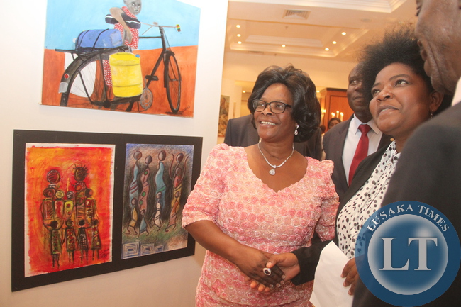 First Lady Esther Lungu admires the paintings during the 69th Anniversary celebrations of UNICEF at Pamodzi Hotel in Lusaka on Thursday evening, December 10,2015 -Picture by THOMAS NSAMA