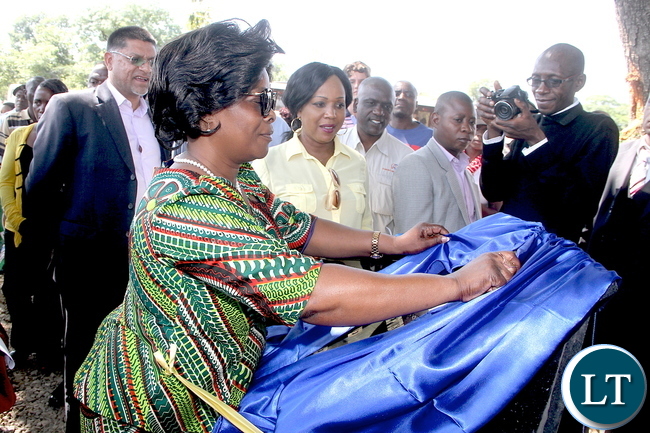 First Lady Esther Lungu unveils a plaque at Nabona farm, the farm that will be used as a collection point for farm produce from villagers. Nabona farm in partnership with KCM will help find the market and sell the farm produce on behalf the villagers. First Lady Esther Lungu unveils a plaque at Nabona farm, the farm that will be used as a collection point for farm produce from villagers. Nabona farm in partnership with KCM will help find the market and sell the farm produce on behalf the villagers.