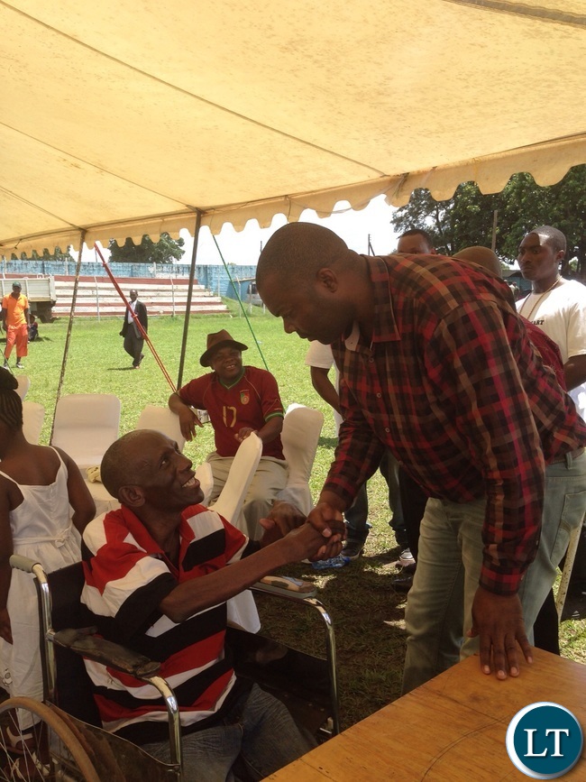 Mr Lusambo shakes hands with one of the receipients