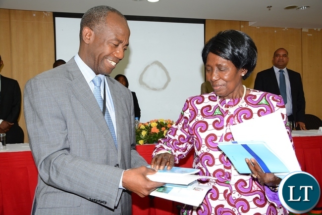 Vice President Inonge Wina cuts the ribbon whilst DMMU Coordinator Patrick Kangwa helps in holding the basket during the Launch of the Disaster Management Policy and Settlement at Government Complex