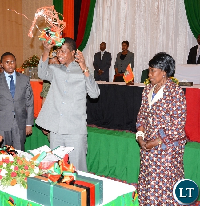 President Eedgar Lungu Cuts the ribbon whilst Vice President Inonge Wine Looks on during the Launch of the Perfromance-Based Contract system for Permanent secretaries at Government Complex