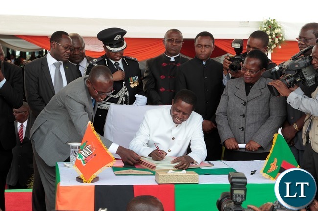 President of the Republic of Zambia, Mr. Edgar Chagwa Lungu signing the Constitution Bill during the Assenting of the Constitutional Bill Ceremony at Heroes Stadium yesterday 05-01-2016. Picture by ROYD SIBAJENE/ZANIS President of the Republic of Zambia, Mr. Edgar Chagwa Lungu signing the Constitution Bill during the Assenting of the Constitutional Bill Ceremony at Heroes Stadium yesterday 05-01-2016. Picture by ROYD SIBAJENE/ZANIS