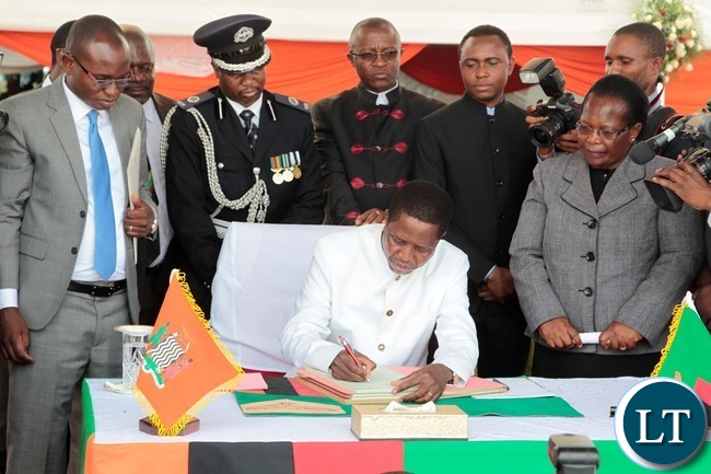 President of the Republic of Zambia, Mr. Edgar Chagwa Lungu signing the Constitution Bill during the Assenting of the Constitutional Bill Ceremony at Heroes Stadium yesterday 05-01-2016. Picture by ROYD SIBAJENE/ZANIS President of the Republic of Zambia, Mr. Edgar Chagwa Lungu signing the Constitution Bill during the Assenting of the Constitutional Bill Ceremony at Heroes Stadium yesterday 05-01-2016. Picture by ROYD SIBAJENE/ZANIS