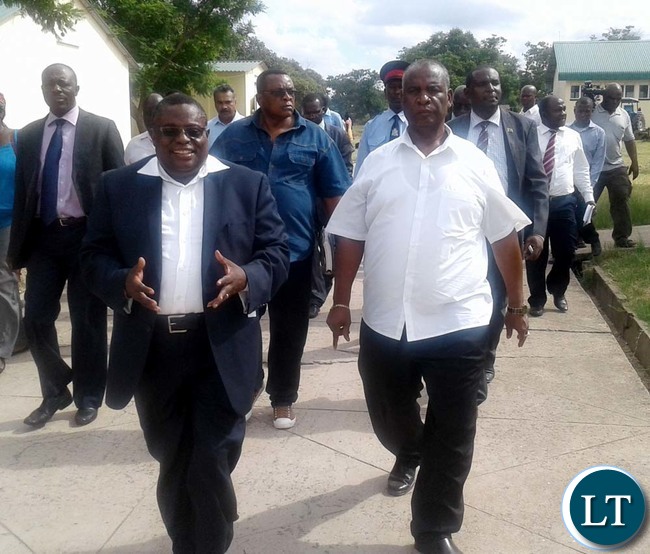 CHOMA Trades Training Institute principal Tom Kapamba (left) shows Southern Province deputy Permanent Secretary Douglas Ngimbu (middle), Higher Education Minister Michael Kaingu (in white shirt) and College vice board chairperson Subi Thomas (far right) some school desks being made by carpentry students at the College