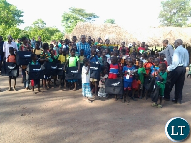 Malambo Patriotic Front Member of Parliament Jacob Shuma with Chitilila community school pupils in Mambwe.The grass thatched community school is serving a number of pupils who had not enrolled due to distances to the nearest schools.
