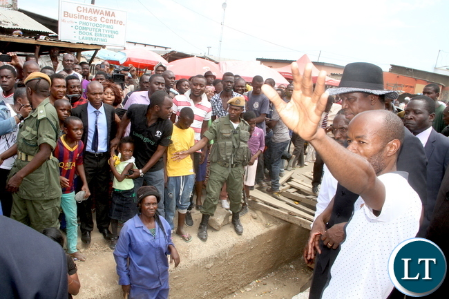 President Lungu inspects drainages in Lusaka Chawama constituency after attending Mass at St Regina Catholic Parish on Sunday, January 3,2015 -Picture by THOMAS NSAMA