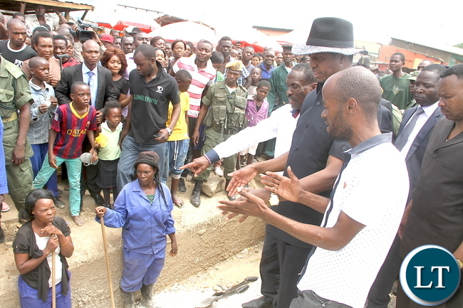 President Lungu inspects drainages in Lusaka Chawama constituency after attending Mass at St Regina Catholic Parish on Sunday, January 3,2015 -Picture by THOMAS NSAMA