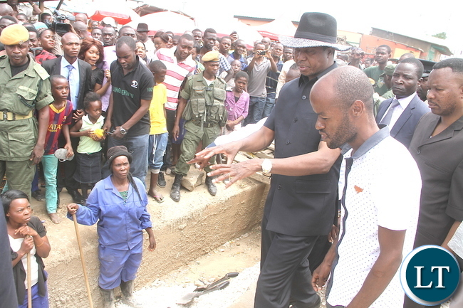 President Lungu inspects drainages in Lusaka Chawama constituency after attending Mass at St Regina Catholic Parish on Sunday, January 3,2015 -Picture by THOMAS NSAMA