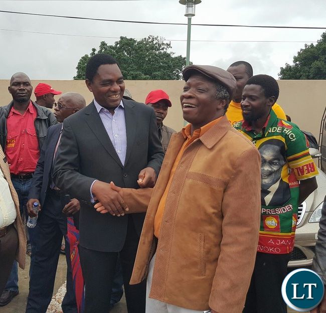 UPND leader Hakainde Hichilema shares a light moment with People's Party President Mike Mulongoti at the Courtyard Hotel in Lusaka after a joint press conference by various opposition political parties in Zambia.