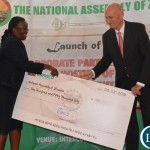 -Clerk of the National Assembly Doris Katai Mwinga(l) receives a dummy cheque  from Southern Cross Motors limited General Manager Tony Voorhout(r) during the launch of the IPU Corporate partnership at intercontinental