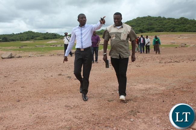 Ithezi Thezi member of parliament who is also Deputy Minister of Agriculture Greyford Monde walks on the Bank of Ithezi thezi Dam with Zesco spokesperson Henry Kapata in Ithezi Thezi. Ithezi Thezi member of parliament who is also Deputy Minister of Agriculture Greyford Monde walks on the Bank of Ithezi thezi Dam with Zesco spokesperson Henry Kapata in Ithezi Thezi.