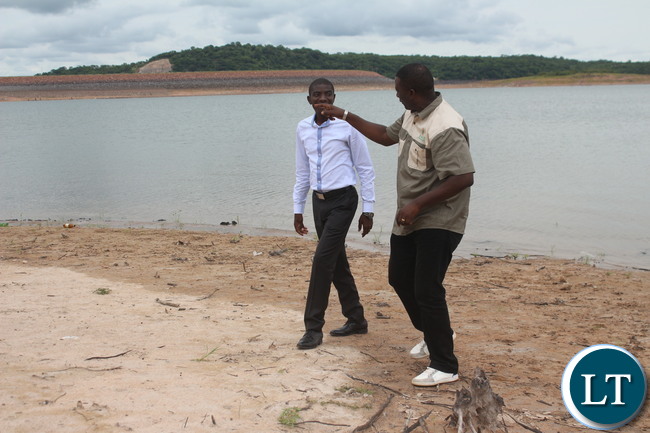 Ithezi Thezi member of parliament who is also Deputy Minister of Agriculture Greyford Monde walks on the Bank of Ithezi thezi Dam with Zesco spokesperson Henry Kapata in Ithezi Thezi. Ithezi Thezi member of parliament who is also Deputy Minister of Agriculture Greyford Monde walks on the Bank of Ithezi thezi Dam with Zesco spokesperson Henry Kapata in Ithezi Thezi.
