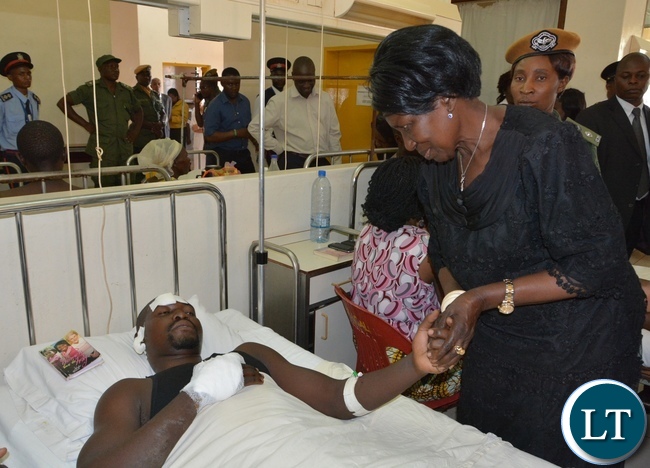 Vice President Inonge Wina comforts one of the victim from the fire fighters accident Kapambwe Phiri at Mtendere Mission Hospital in Chirundu District