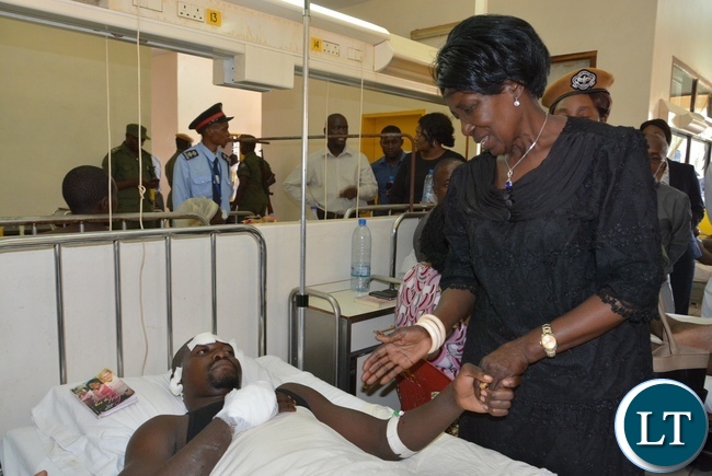 Vice President Inonge Wina comforts one of the victim from the fire fighters accident Kapambwe Phiri at Mtendere Mission Hospital in Chirundu District