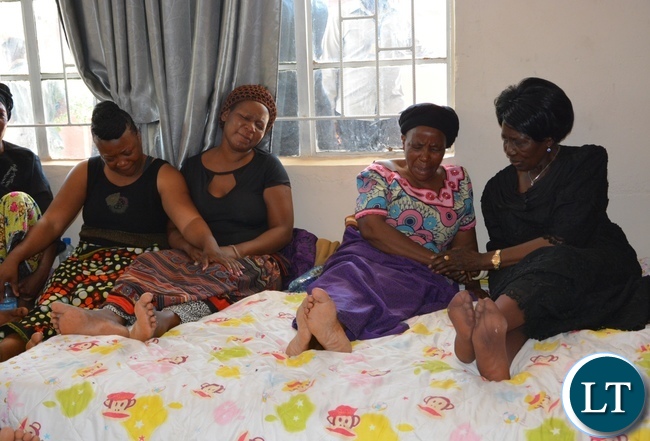 Vice President Inonge Wina(r) comforts mourners at one of the victims from the fire fighters accident funeral house in Chirundu District