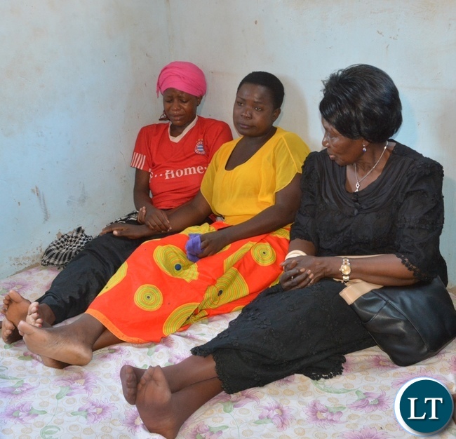 Vice President Inonge Wina(r) comforts mourners at one of the victims from the fire fighters accident funeral house in Chirundu District
