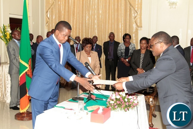 President Edgar Lungu receive the orth from newly appointed Constitutional Court judge Justice Palan Mulonda at State House