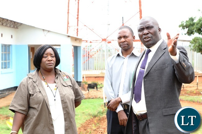 Shibuyunji School Manager,Denny Sinkamba (R) explaining to Assistant, Information and Communication during the tour of Shibuyunji District on decentralisation for good governance Shibuyunji School Manager,Denny Sinkamba (R) explaining to Assistant, Information and Communication during the tour of Shibuyunji District on decentralisation for good governance