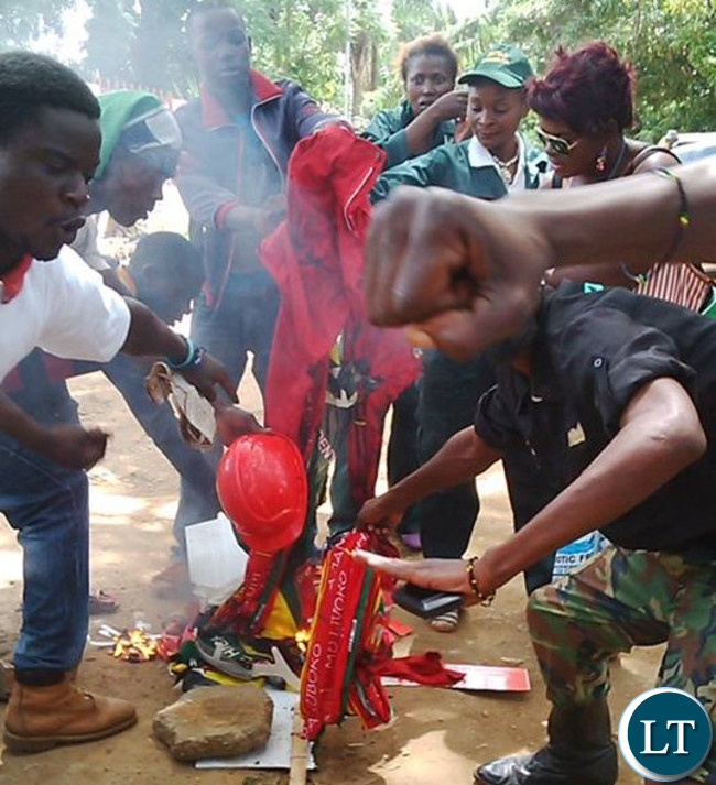 PF cadres burn UPND party regalia after the youths of the two political parties clashed against each other during the Youth Day Celebrations in Lusaka with one PF youth wearing the military outfit the party banned