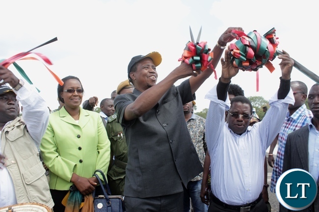 President Edgar Lungu (c) cuts the ribbon to officially commission the Sioma Bridge built at a cost of K108.2million in Sioma District of Western Province