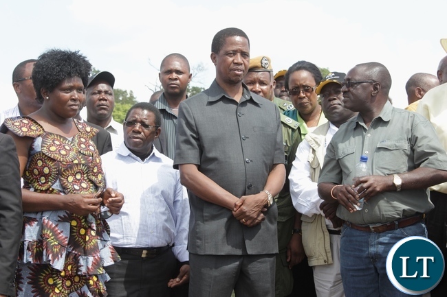 President Edgar Lungu (c) listens from Pettit and Partners Consultants Resident Engineer Ernest Masaiti (r) the contractors of Sioma Bridge as Road Development Agency (RDA) Communications Director Loyce Saili (l) looks on during the official commissioning of the bridge built at a cost of K108.2million in Sioma District of Western Province