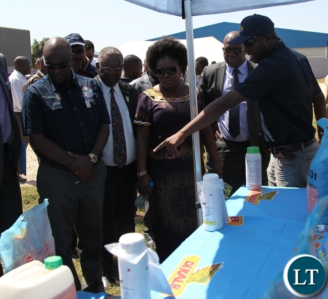 Deputy Minister of labour and social security Alfreda Kansembe Mwamba with Mansanto country director Donald Mavindindze looks at Mansanto product .during the official commemoration of the world day for safety and health at work