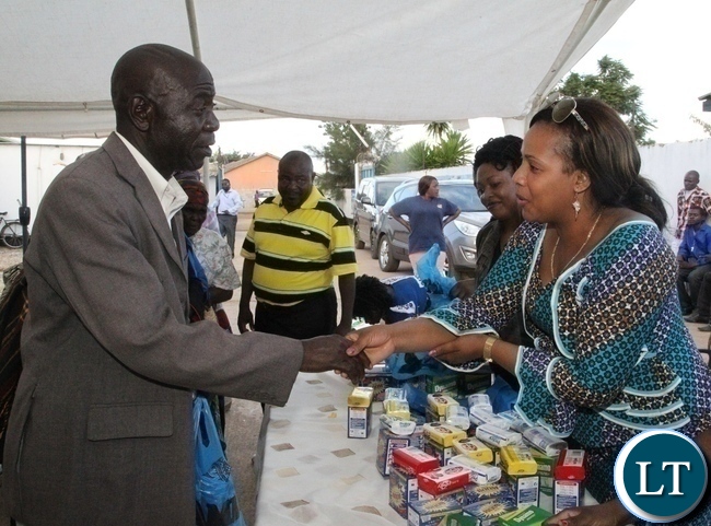 One of the beneficiaries of Divine Mercy Home Care Baidwin Chungu(l) thanking wife to kabwata area member of parliament Ireen Lubinda(r) for donating assorted goods to the aged in Chilenje One of the beneficiaries of Divine Mercy Home Care Baidwin Chungu(l) thanking wife to kabwata area member of parliament Ireen Lubinda(r) for donating assorted goods to the aged in Chilenje