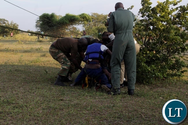 Zambia Air Force and Zambia Army Special Forces rescue team untying some of the victims of the 22 Engineering Services Corporation (ESCO) workers after air lifting them from the pontoon that was carried away by strong currents and got stuck towards Ngonye Falls on the Zambezi River in Sioma District