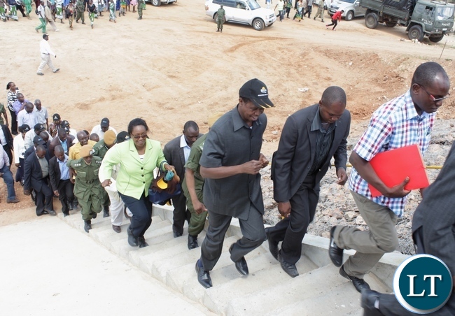 President Edgar Lungu (l) runs to climb the stairs to the bridge during the official commissioning of the Sioma Bridge built at a cost of K108.2million in Sioma District of Western Province