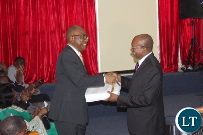 Angolan Consul General for Mongu Domingo Mazala Ricardo (r) hands over an album to Angolan Secretary General for the Ministry of Foreign Affairs Eduardo De Jesus (l) at the Inauguration Ceremony for the Consulate of the Republic of Angola in Mongu